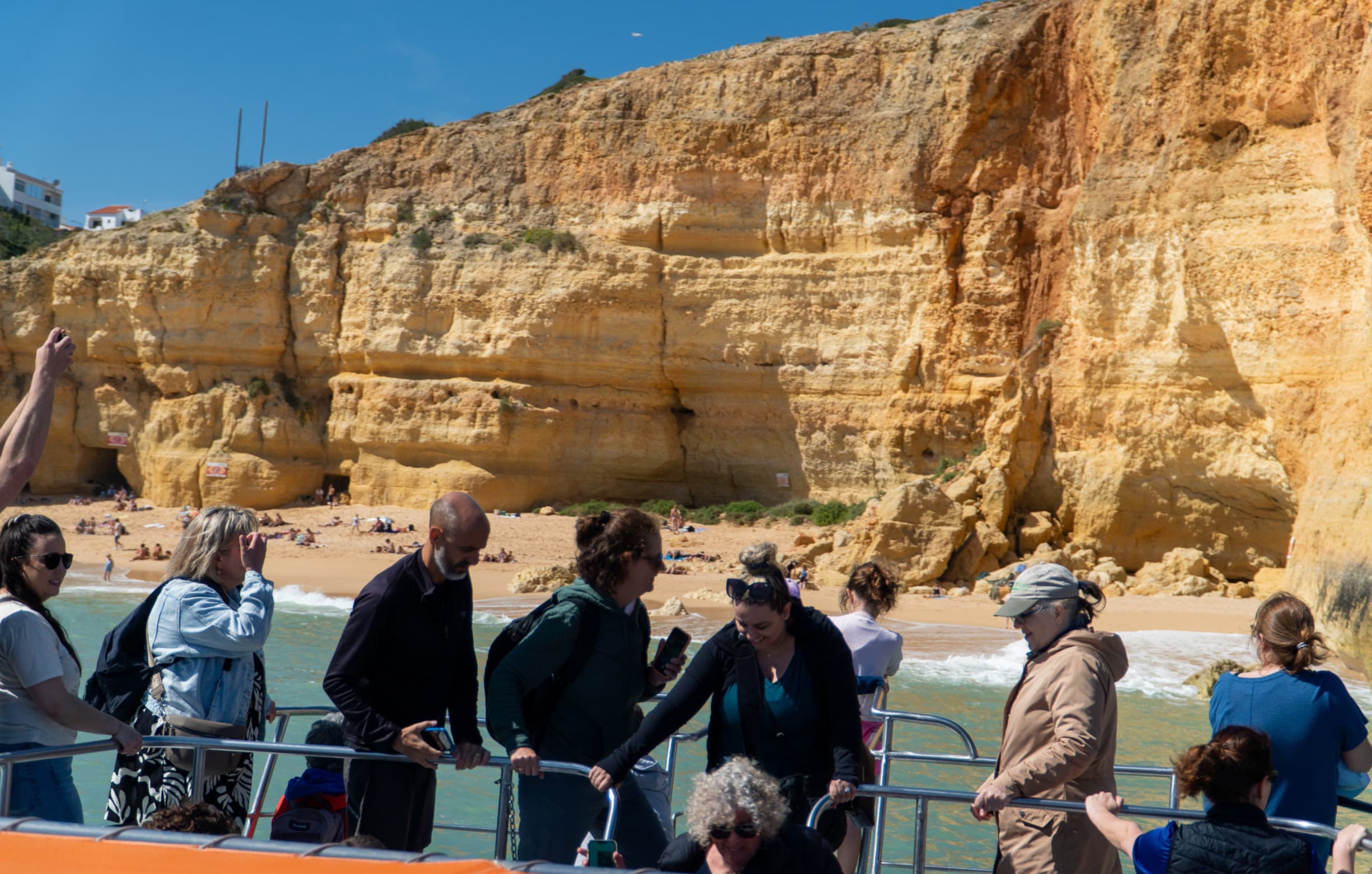 Tourists exploring the Algarve coast on a catamaran cruise