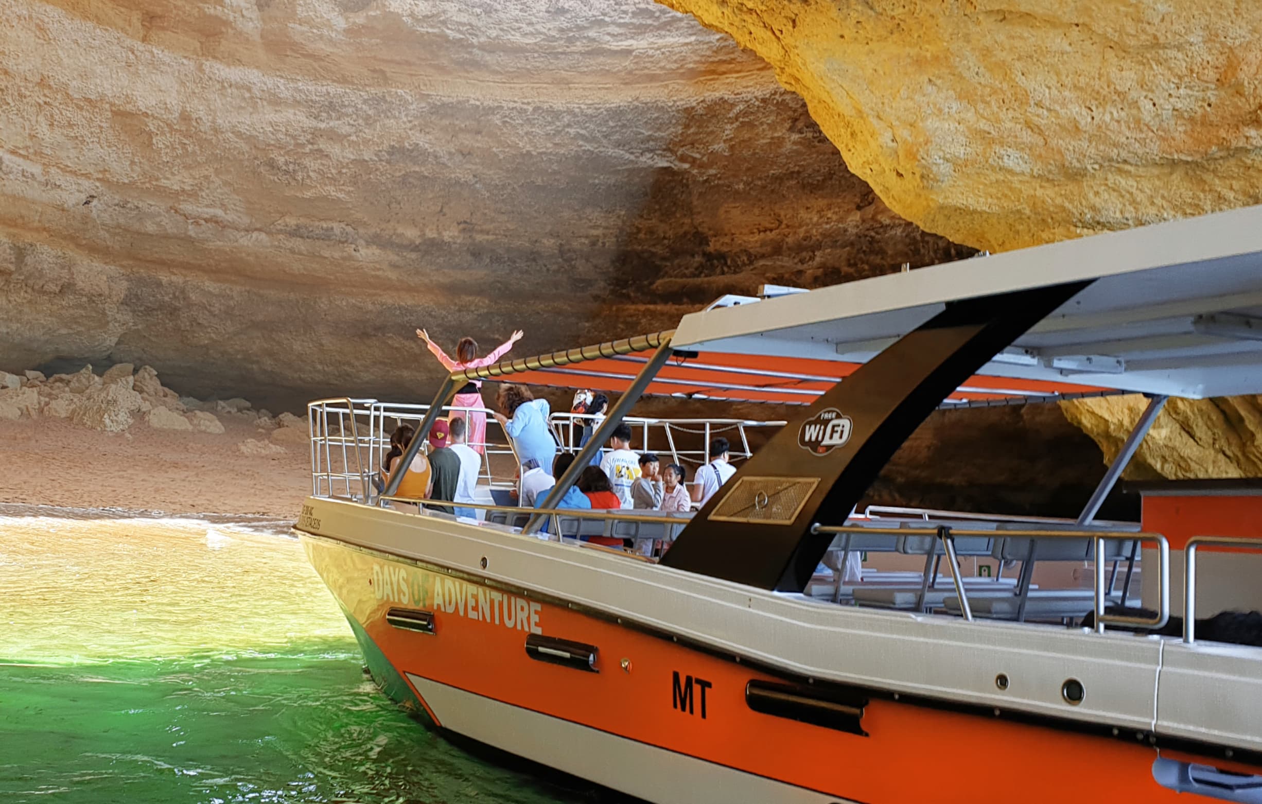 Passengers enjoying a Benagil catamaran tour from Lagos