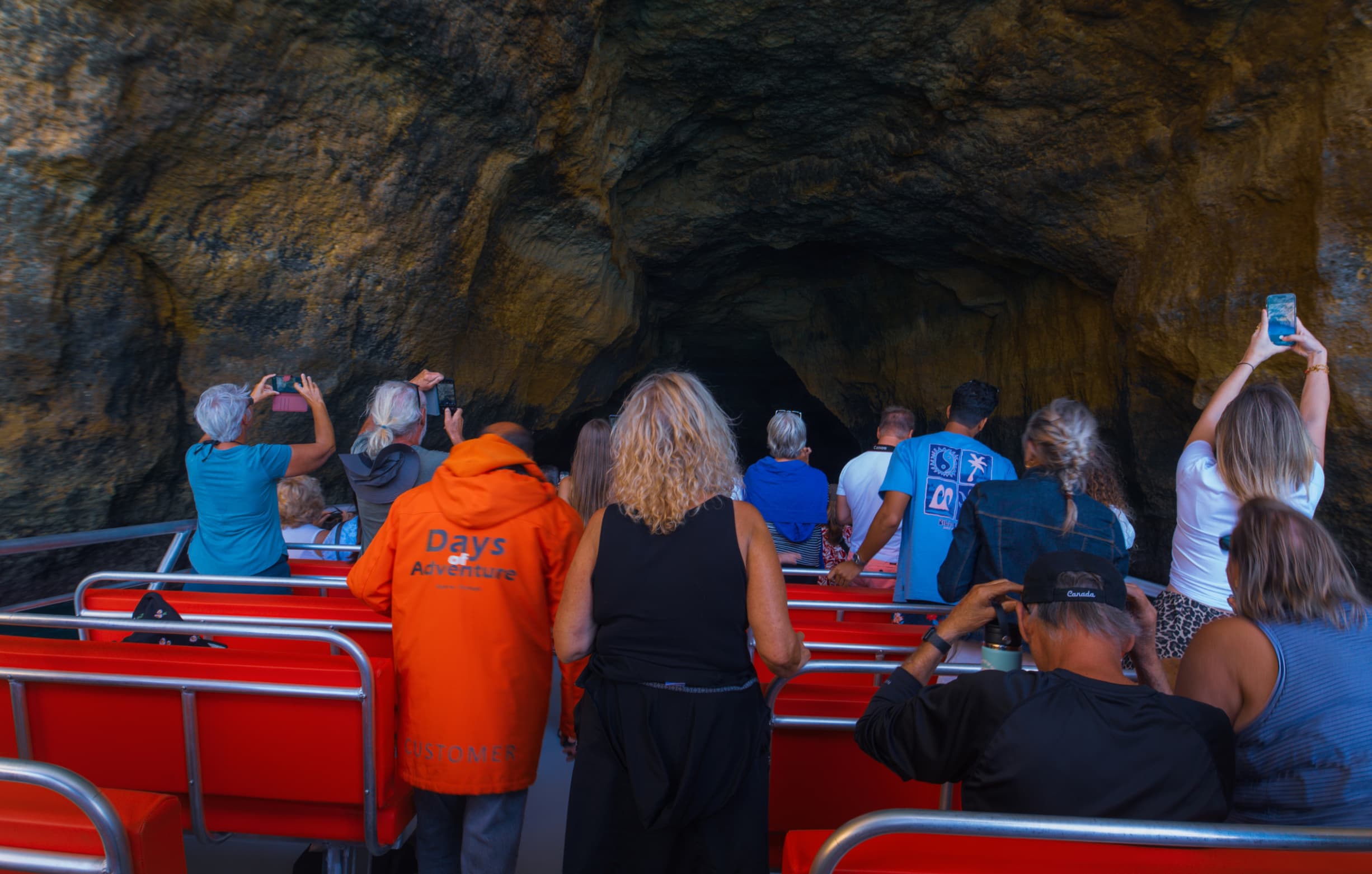Tourists spotting dolphins during a Benagil combo tour