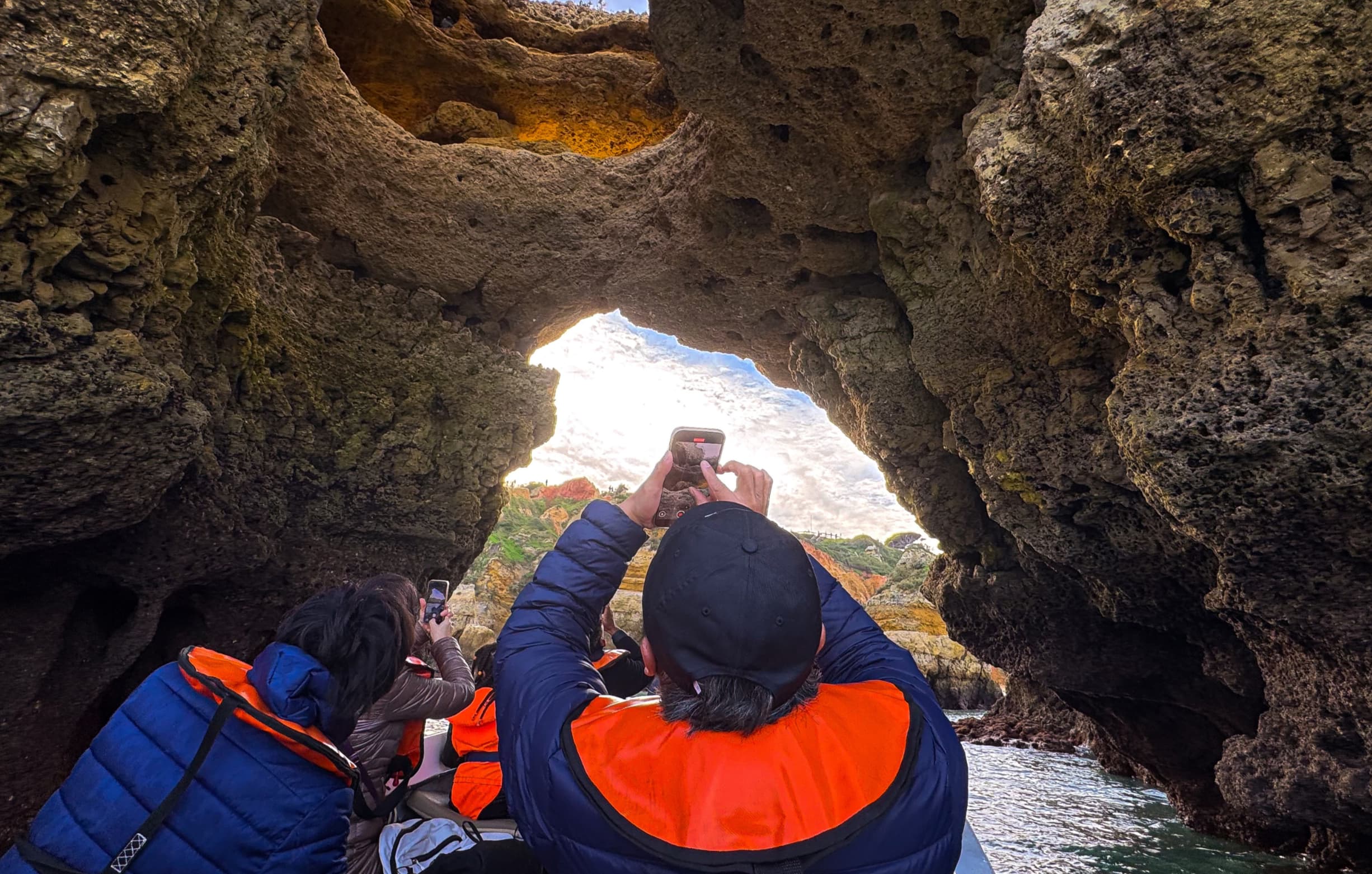 Traditional boat entering the sea caves of Ponta da Piedade